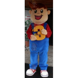 Leende ung pojke BIGGYMONKEY™ maskotdräkt klädd i overall -