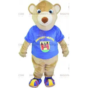 Maskotka beżowego misia BIGGYMONKEY™ z niebieskim t-shirtem.