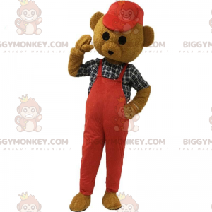 Brun Teddy BIGGYMONKEY™ maskotdräkt klädd i rött med en keps -