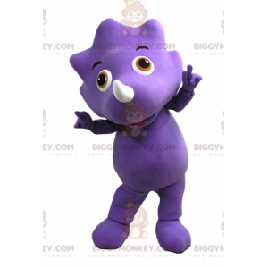 Purppura dinosaurus BIGGYMONKEY™ maskottiasu oransseilla